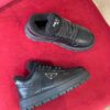 PRADA BLACK LEATHER AND SHEARLING SNEAKERS - P060